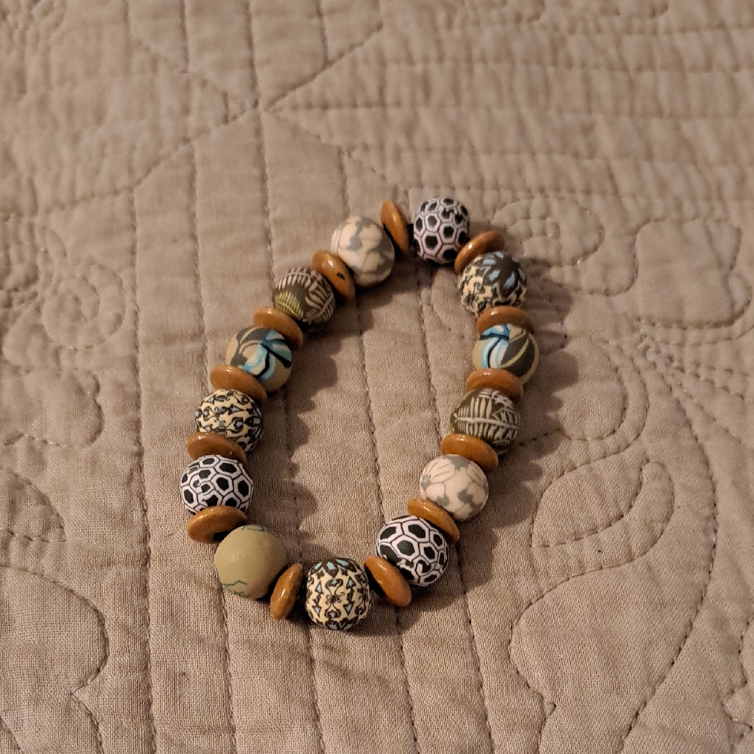 Cream And Tan Beaded Bracelet With Intricate Patterns